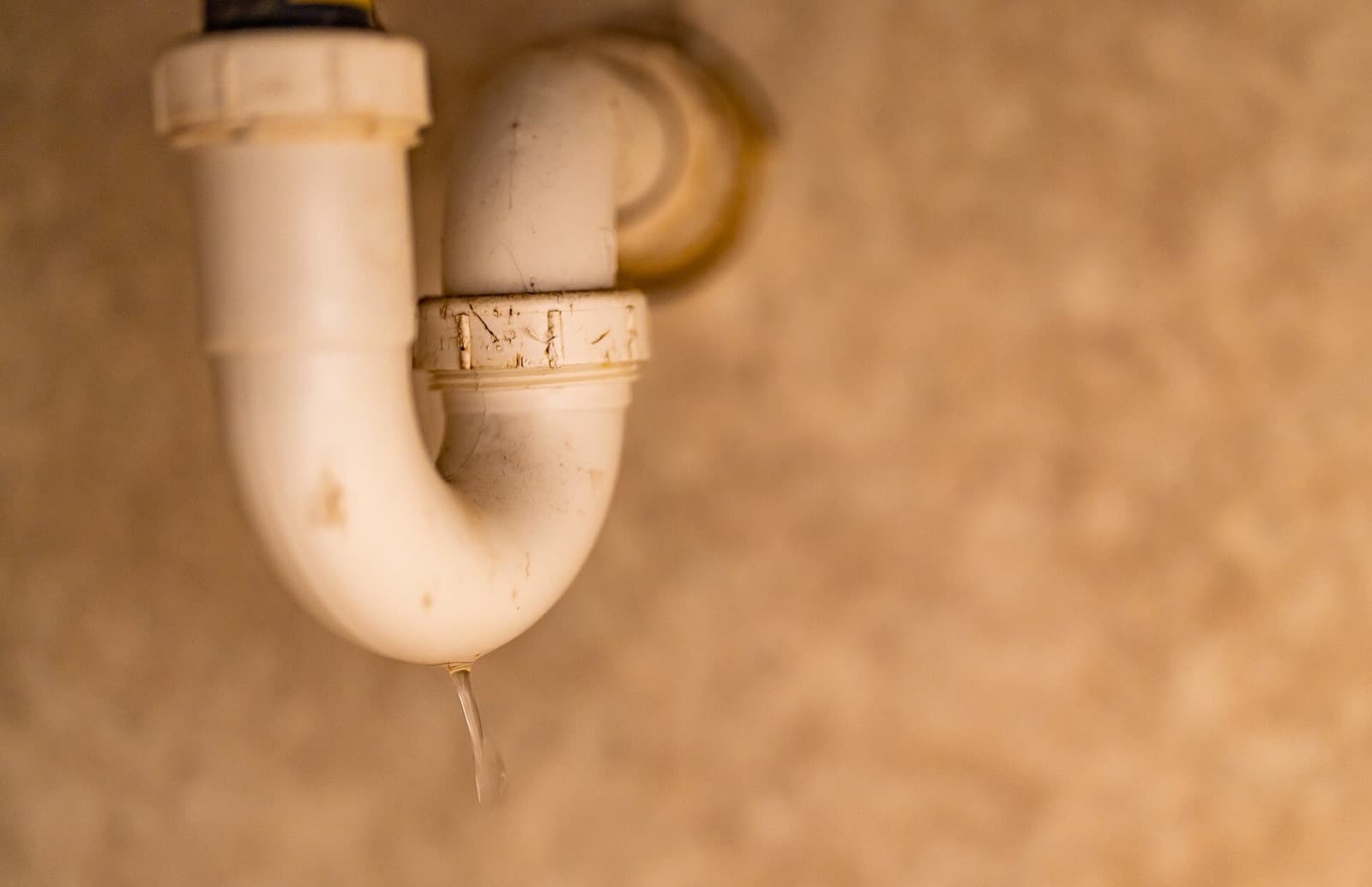 Water dripping from a P-trap under a sink